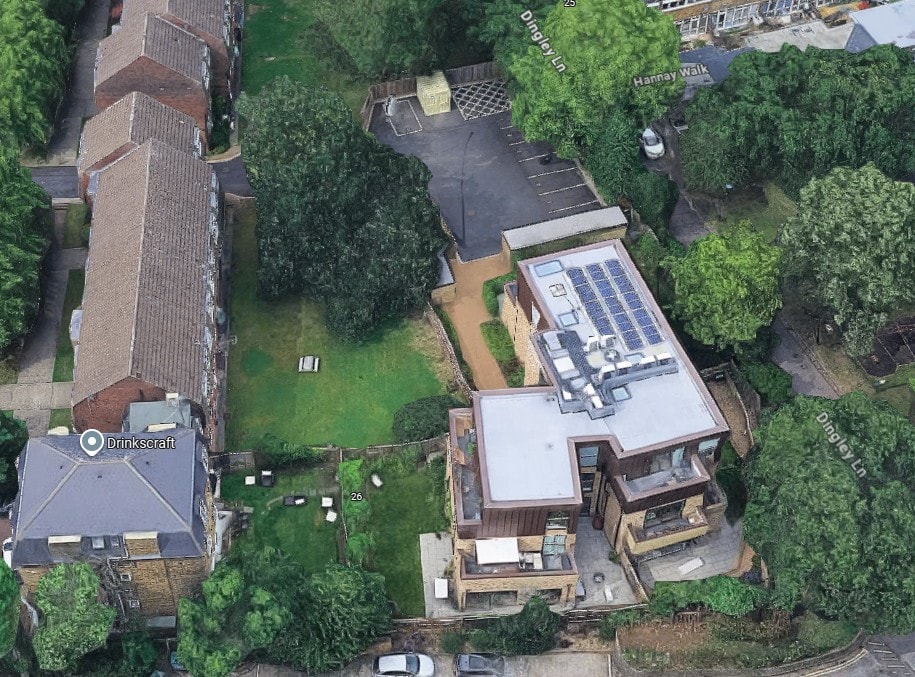 Colin Court — aerial photograph of completed building showing flat roof with solar panels and surrounding context
