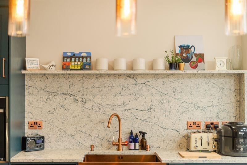 Kitchen detail with marble splashback and copper fittings