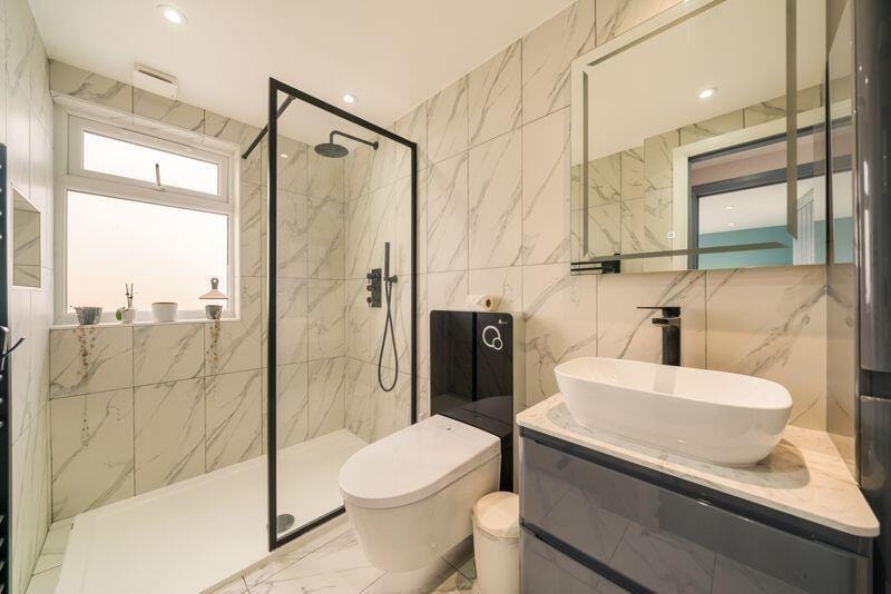 Contemporary en-suite with marble tiles and walk-in shower