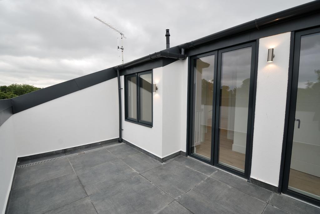 Golden Manor — roof terrace with slate paving and black aluminium bi-fold doors