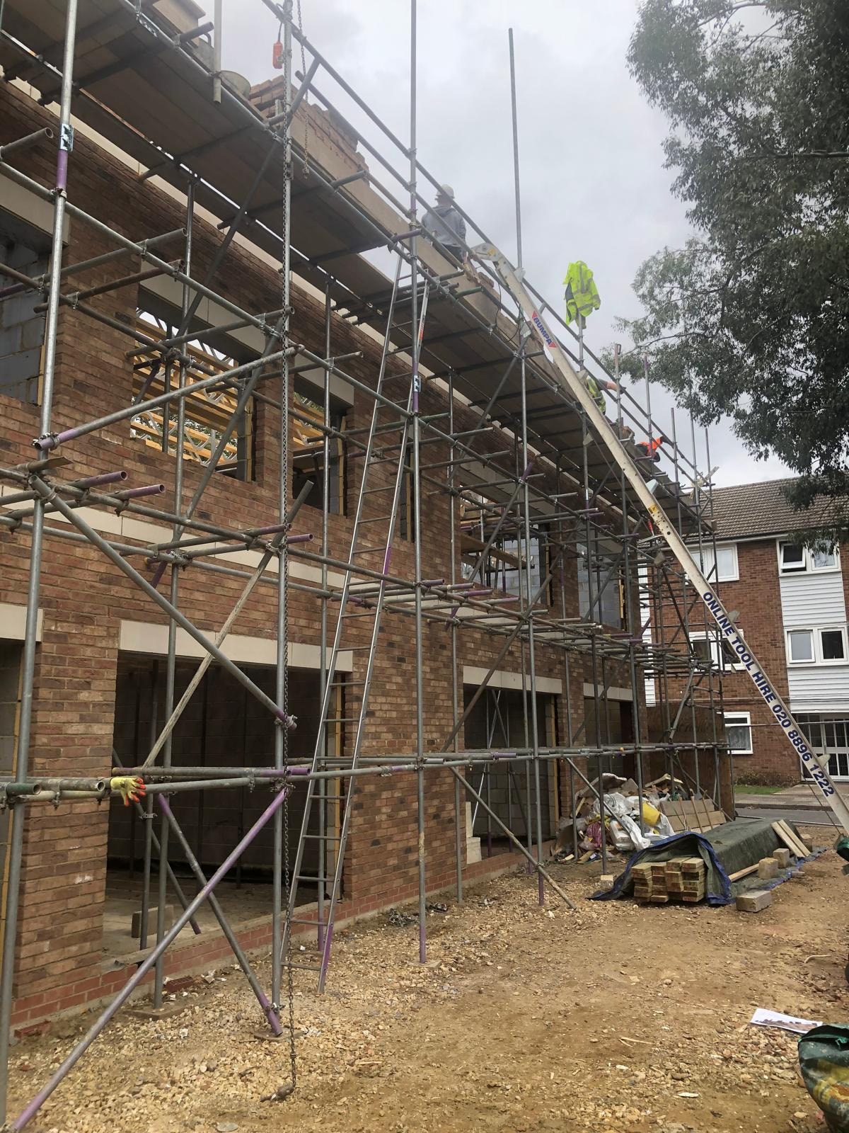 Golden Manor — construction progress showing brickwork and scaffolding to the main elevation