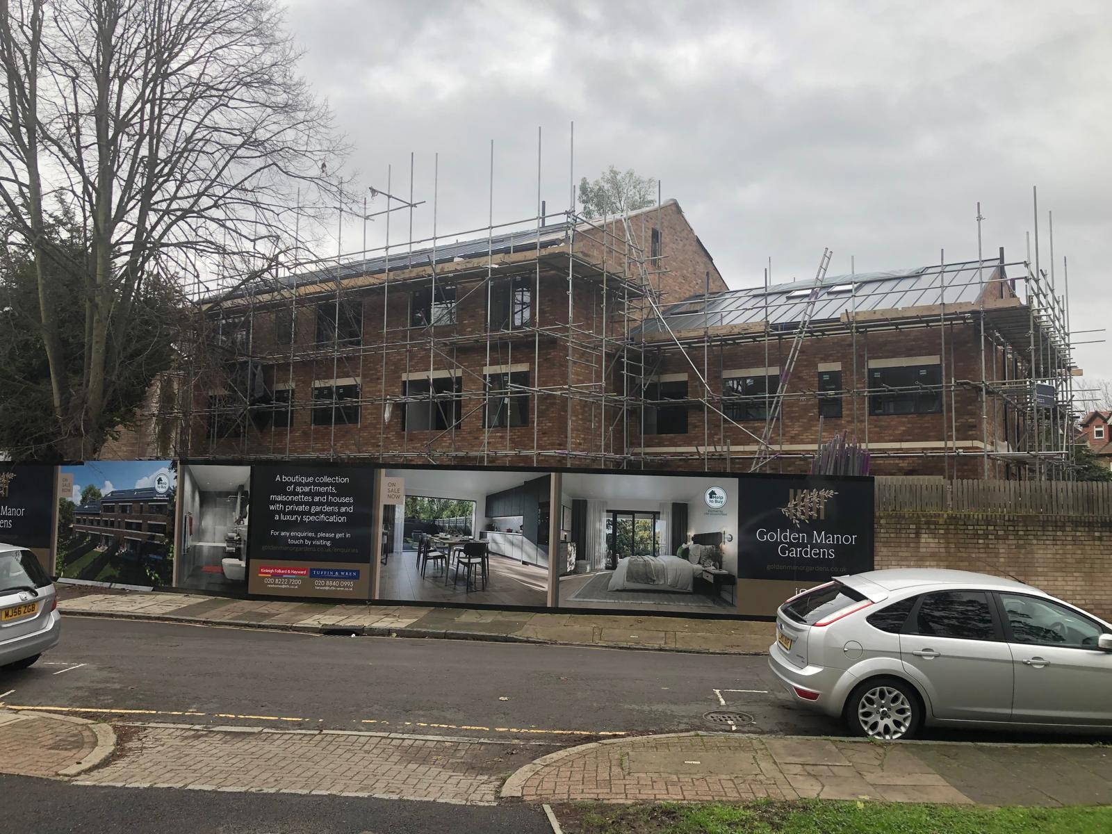 Golden Manor — hoarding with Golden Manor Gardens marketing signage and CGI imagery on site