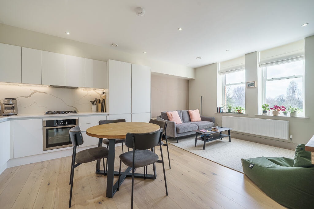 Open-plan kitchen, dining and living space with neutral finishes