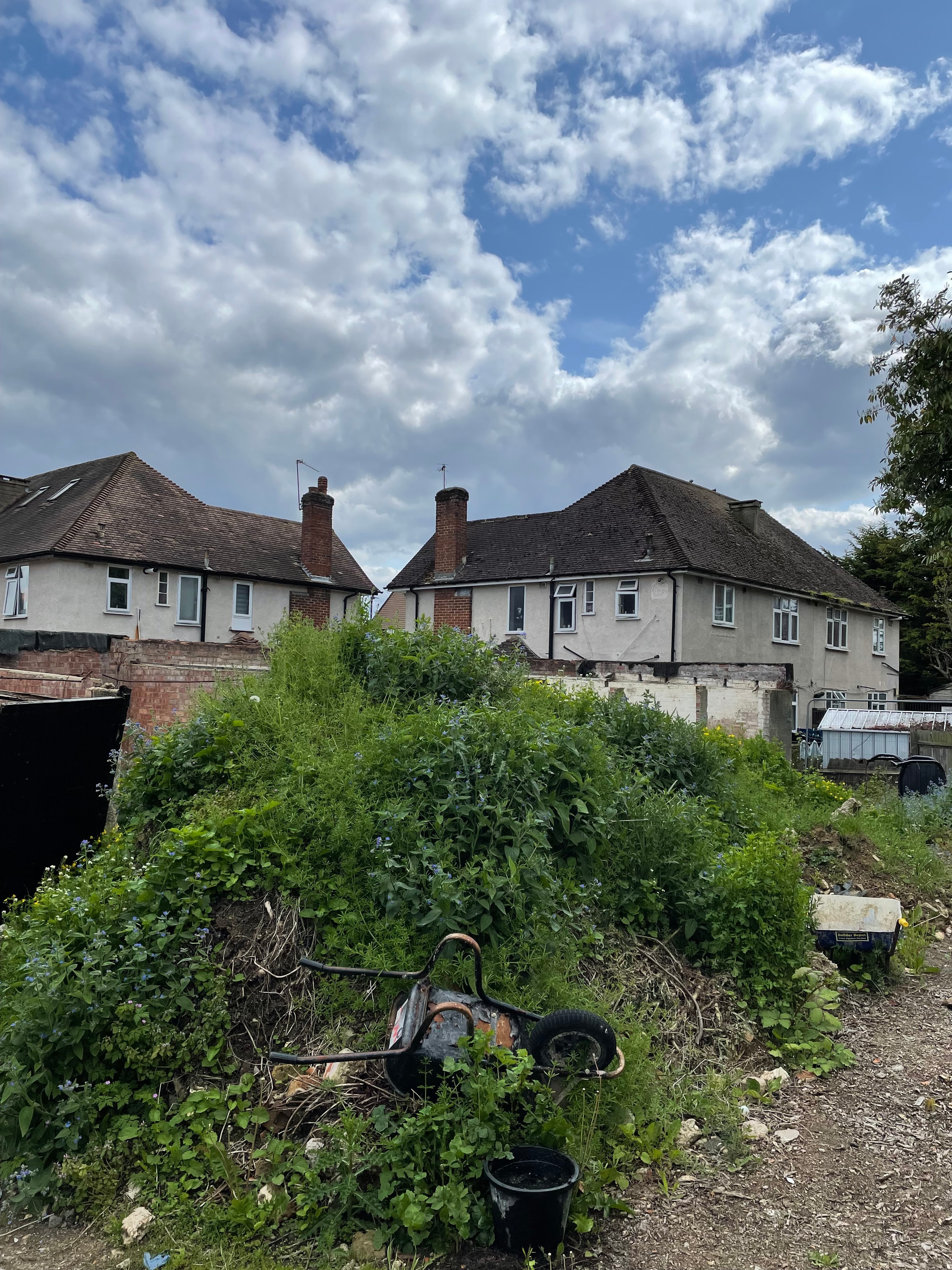Harrow Road — existing garage site before demolition, overgrown plot
