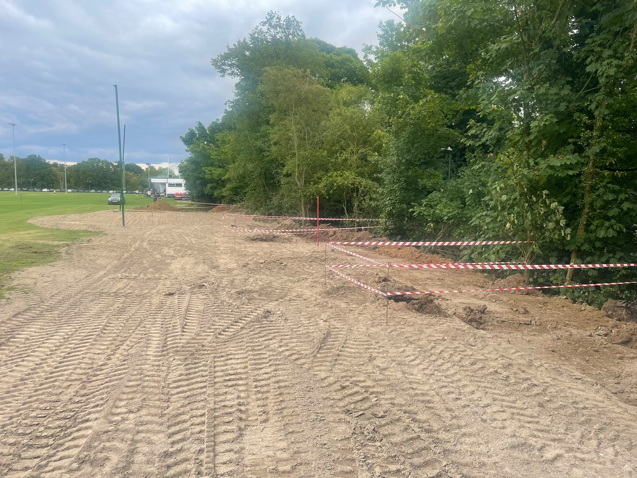 Sports field under construction with safety barriers