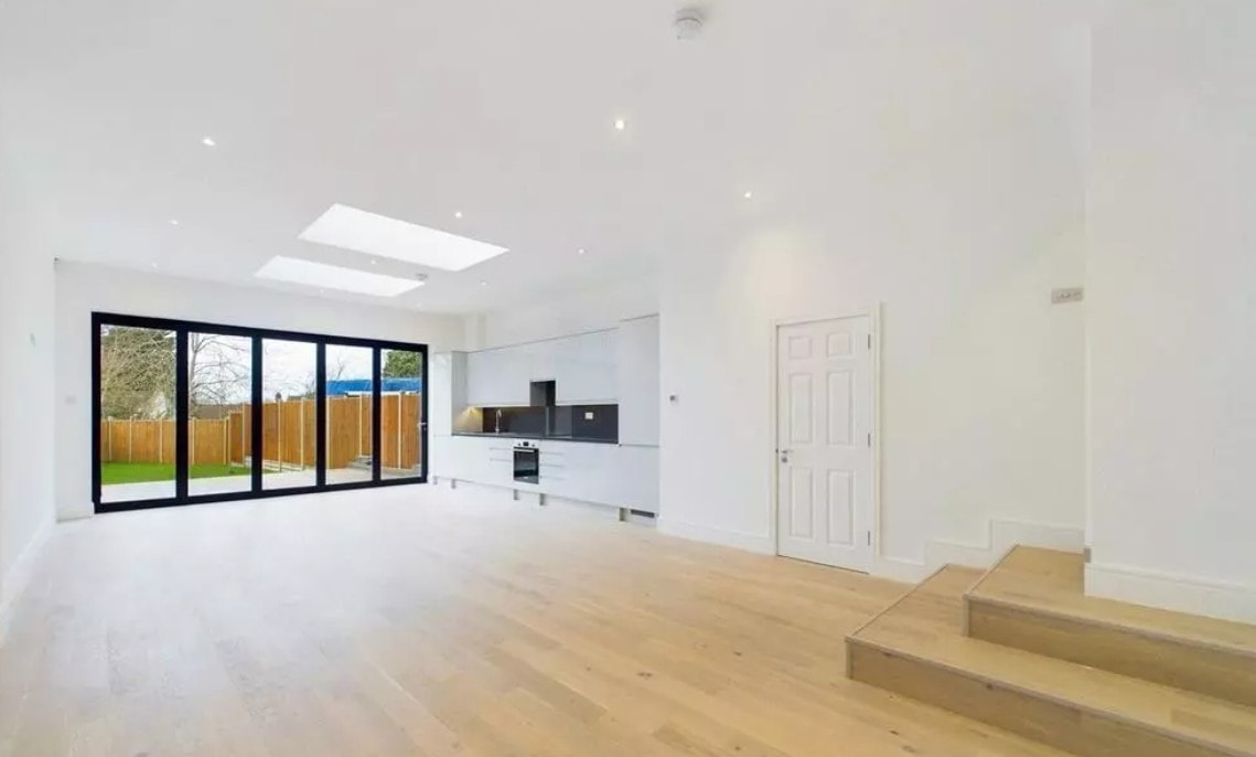 Hillside — completed open plan kitchen and living space with bifold doors, skylight and oak flooring