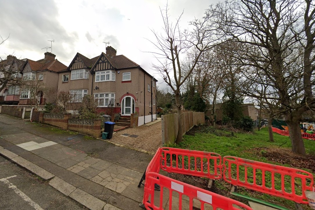 Hillside — existing house front elevation with vacant side plot before new build