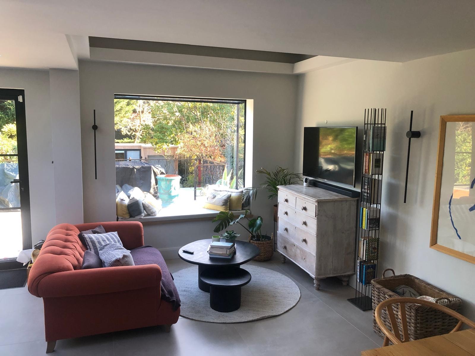 Love Lane — living area with terracotta sofa, bifold doors opening to garden patio