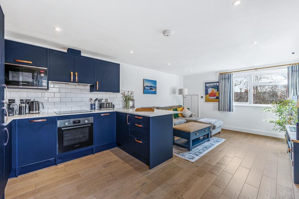 Melbourne Avenue — navy kitchen with copper handles, white metro tile splashback and integrated Bosch appliances