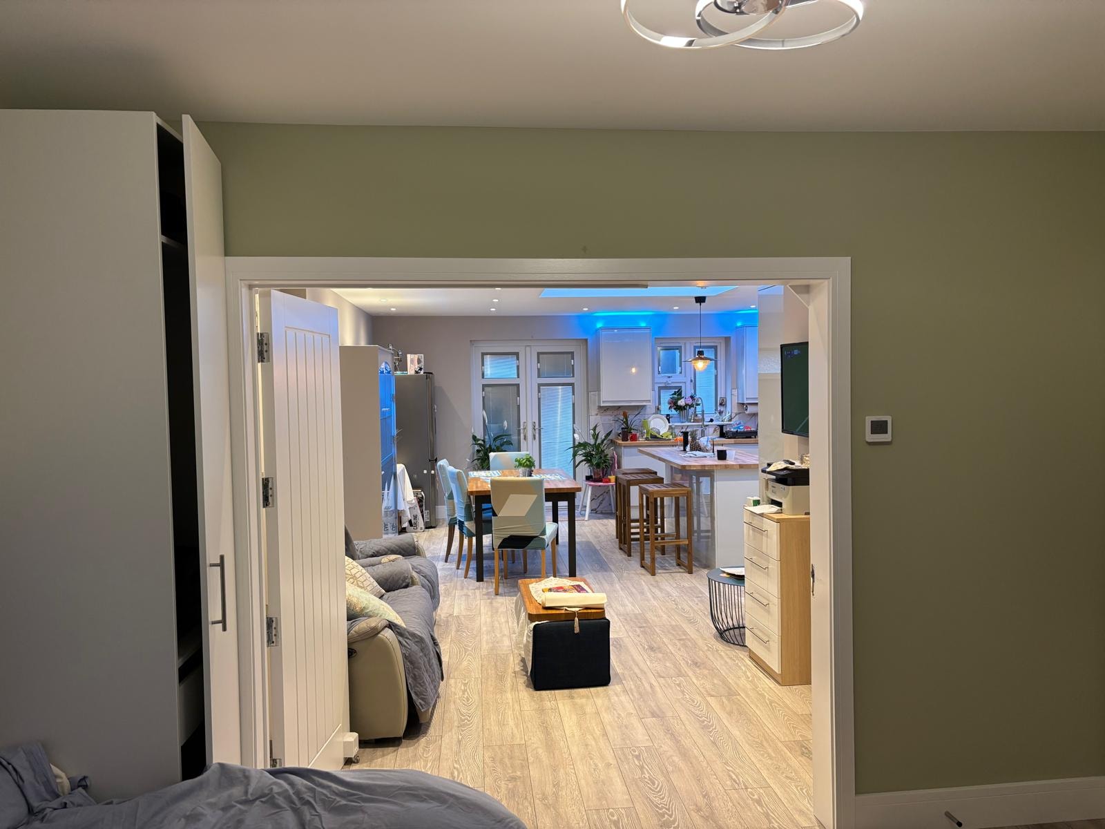 Pursley Road — view through doorway into completed open-plan kitchen and dining area with blue accent lighting