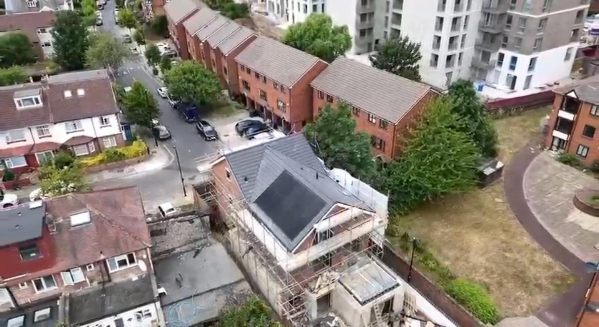 Scouts Hall — aerial drone view of completed building in residential context