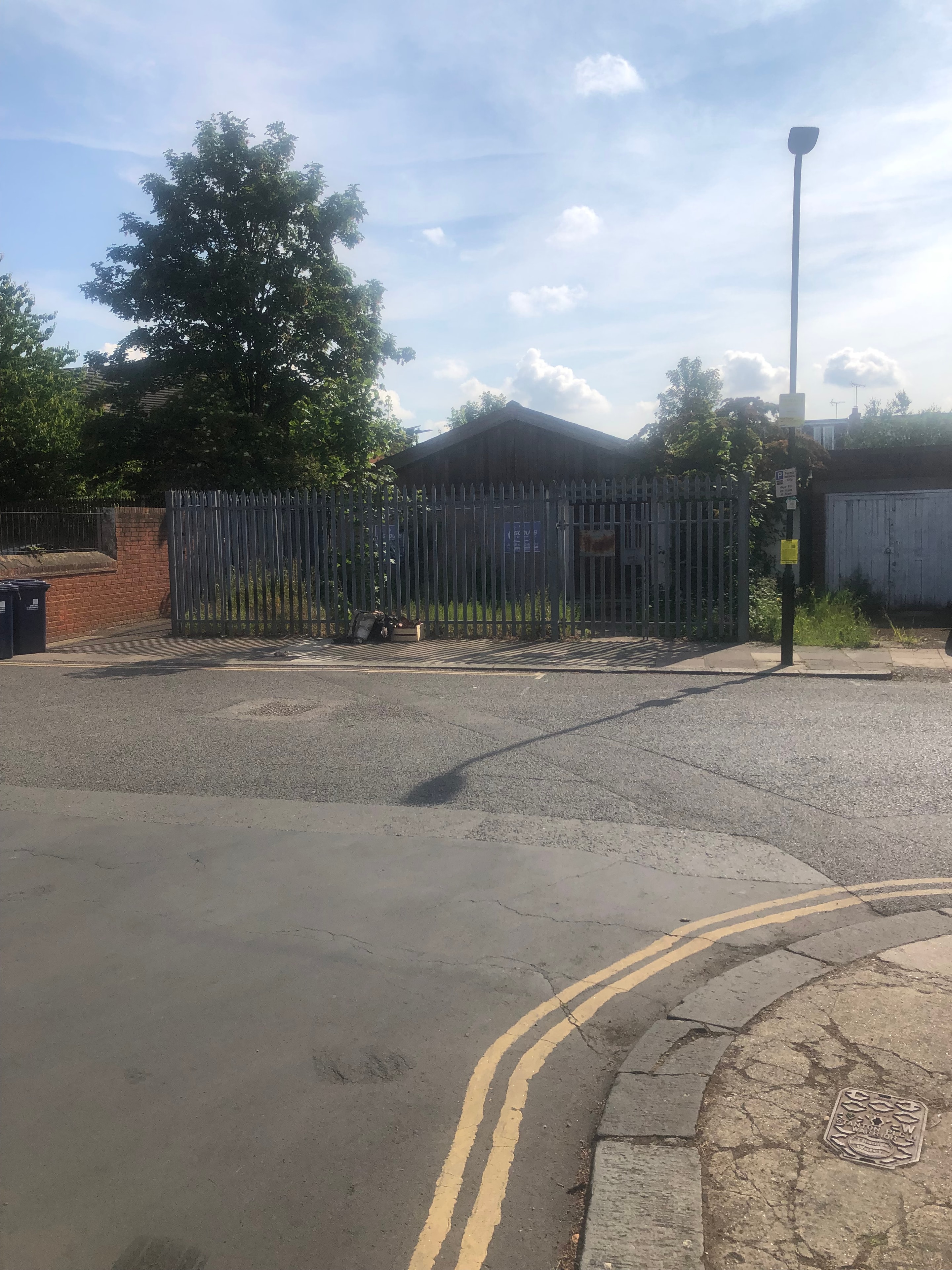 Scouts Hall — existing scouts hall site from street showing iron railings and single-storey building