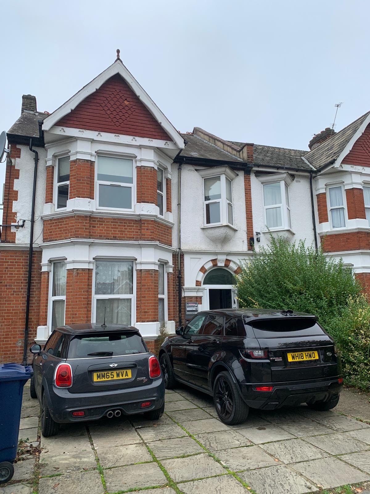 Original front elevation before conversion — Victorian brick and white render with parking