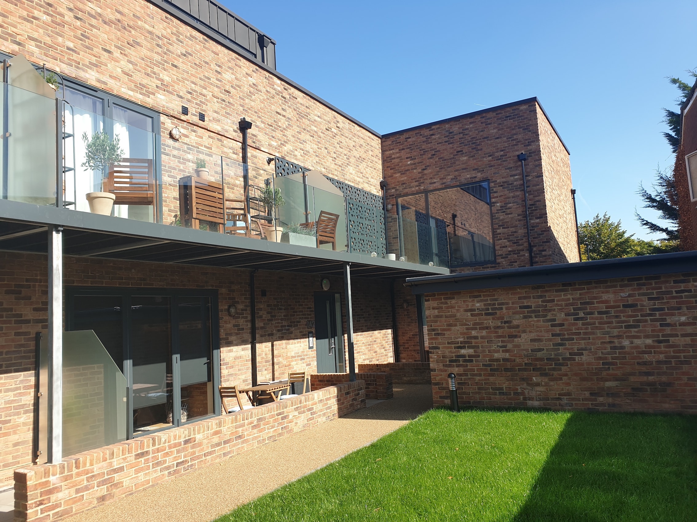 Upper Tulse Hill — completed rear elevation showing balconies, glass balustrades and landscaped communal garden