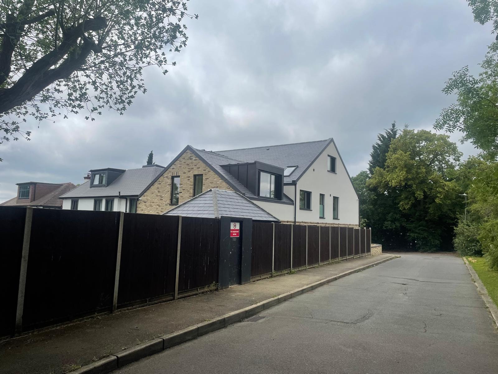 Bellfield Avenue — completed rear elevation with slate roof, zinc dormers and white render finish